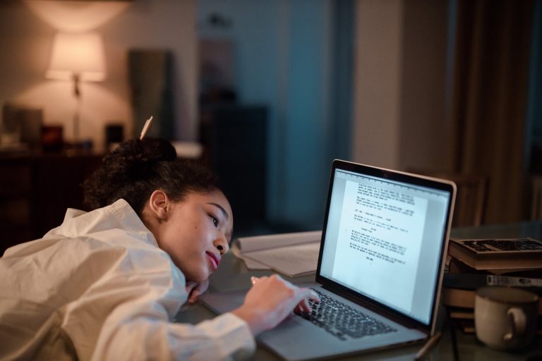 boy in white dress shirt using macbook pro